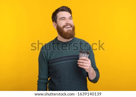 Portrait of happy man drinking his morning coffee TO GO