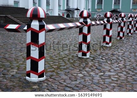 Restored fence with alternating black, red and white in one of the palaces of St. Petersburg