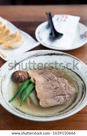Stock soup of bone and stew meat in a bowl 