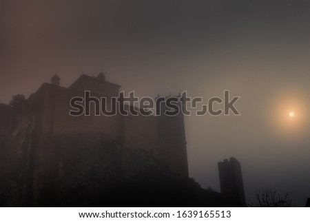 Gothic castle hidden in the fog