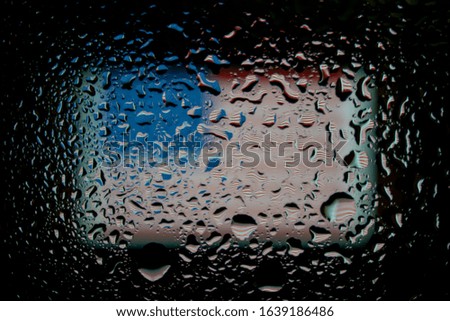 USA flag under glass with water drops. Abstract photo.