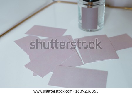 
pink business cards blank on a white table and 
antique bust