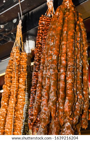 Cevizli sucuk made by dipping a string with walnuts into a grape molasses mixture, the sweet sucuk is then hung out to dry and cut into pieces and enjoyed as a gummi-like dessert. Sweet grape molasse