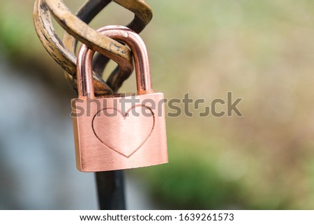 love can last forever. one lock with gravured heart shape on it. close up