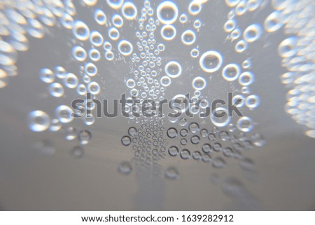 Abstract background close up water drops on dark and bright background in cold bottle.Wallpaper texture background.

