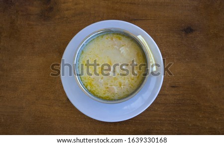Tripe soup in a bowl / plate with lemon on wooden table background. Traditional soup of Gaziantep, Turkey. Famous symbol Turkish cuisine fresh food foams. Veal meat ingredients in regional soup. Khash