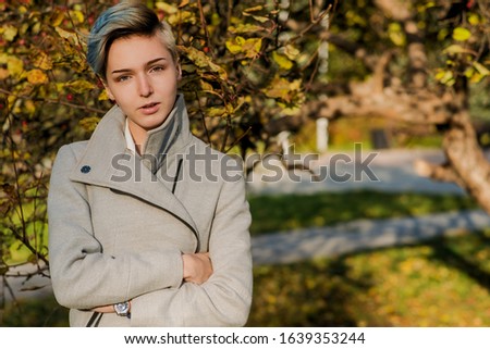 Modern girl with colored short hair in autumn