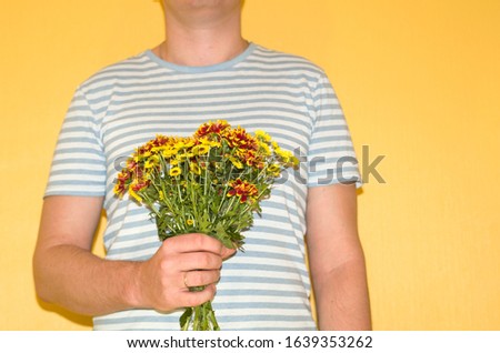 a man is going to give chrysanthemums, an image without a face with space for text