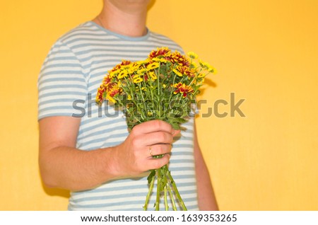 a man is going to give chrysanthemums, an image without a face with space for text