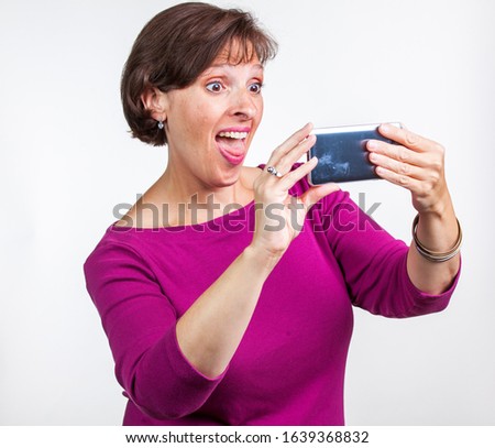 Middle Aged woman taking a selfie. Gen X social media concept image