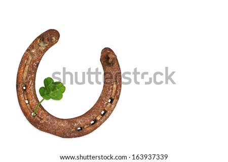 Old horse shoe with four-leaf clover Royalty-Free Stock Photo #163937339