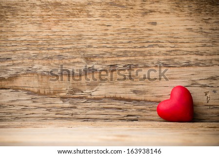 Red heart on the wooden  background.