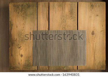 Picnic table/Cookbook background. Brown mat on wooden picnic table.