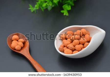 Fried peanuts on a black background indoors