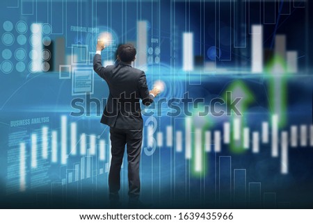 Businessman standing hand touch screen to analyze business and
performance,investment statistics,digital working background virtual panel,chart and financial stock graph,concept business innovation