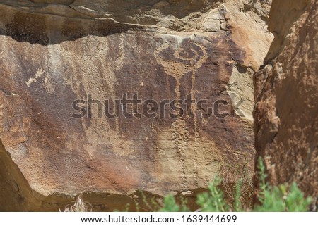 Strange shapes and figures that have been carved into the ancient sandstone rocks at Legend Rock State Petroglyph Site, Wyoming.