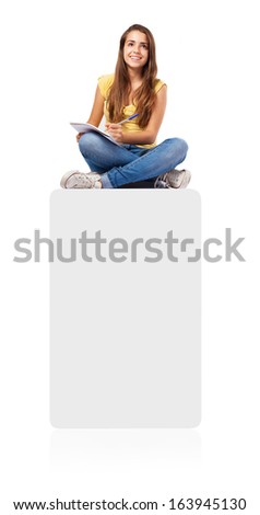 young student woman sitting on a box and studying