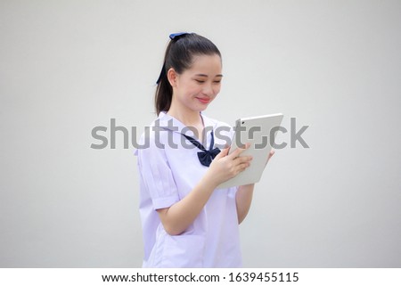 asia thai Junior high school student uniform beautiful girl using her tablet