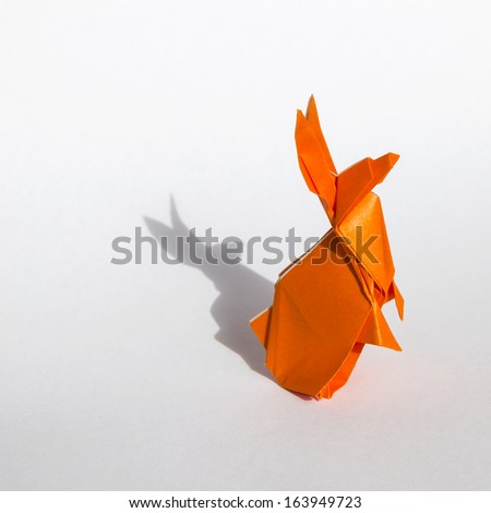 Origami orange rabbit isolated on white