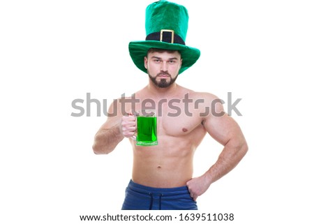 St. Patrick's day. A muscular man in a green hat holds a mug of ale and beer. Isolated white background. ABS.