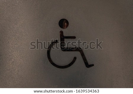 Sign symbol DISABILITIES on the door of a public toilet
