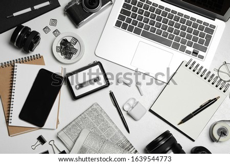 Flat lay composition with equipment for journalist on white table