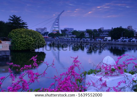 Spring scenery of Anping  Linan Bridge in cloudy morning and short sunshine & Amazing coral vine Blossoms.Tainan,Taiwan. 