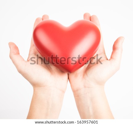 Female hands holding red heart