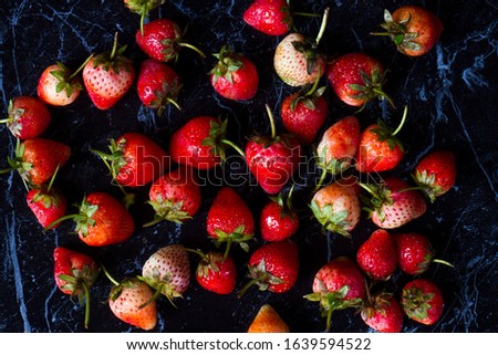 Top of view fresh strawberries on a black background