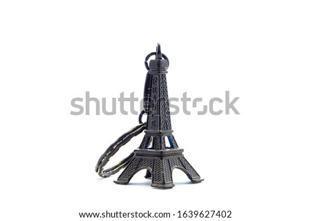 A black Eiffel tower pendant in a white background
