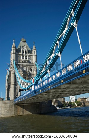Bright sunny daytime view of Tower Bridge with blue sky above the River Thames in London, UK