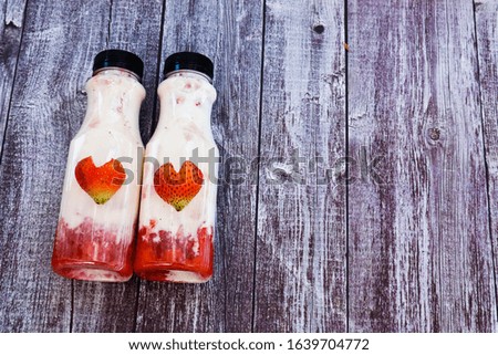 Fresh Crushed Strawberries with Milk in bottles.