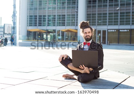 Stylish elegant dreadlocks businessman using notebook in business landscape Royalty-Free Stock Photo #163970498