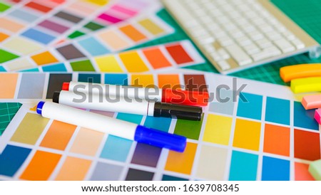 Color palettes and markers on the table. Selection of the most suitable color. Color type of the person. The choice of paint for a new home. Work designer. Royalty-Free Stock Photo #1639708345