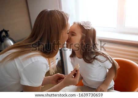 funny mother and her child touching their noses, close up side view photo, craziness, madness, happy childhood, best love, sincere feeling and emotion