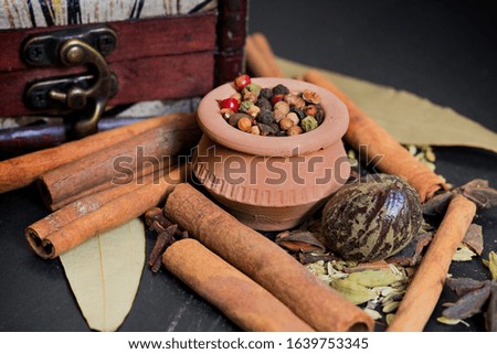 Spices in small mud pot. Cardamom Cinnamon, Black Pepper