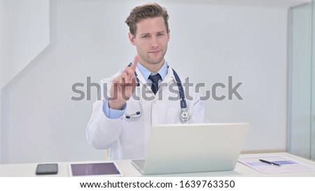Young Doctor saying No with Finger Sign in Clinic
