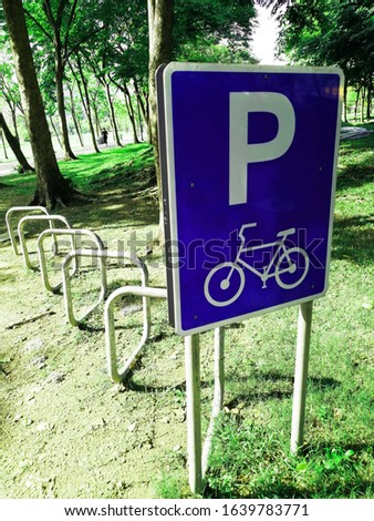 Bicycle parking is provided with signs in the park.