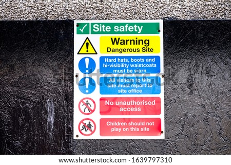 Construction site health and safety message rules sign board signage on boundary wall entrance