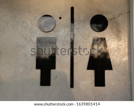 Sign of man and women on wall background