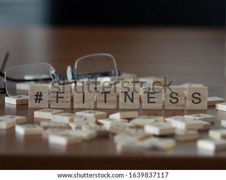  hashtag fitness concept represented by wooden letter tiles