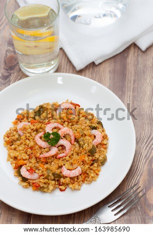 Delicious paella with seafood, wooden background