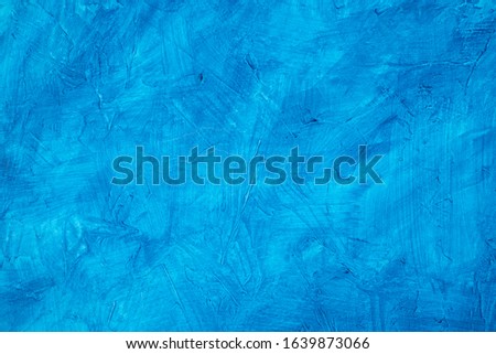 Abstract background of blue colored concrete with a texture.