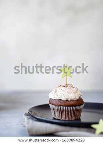 delicious chocolate cupcakes with cream. gray background, vertical image, copy space