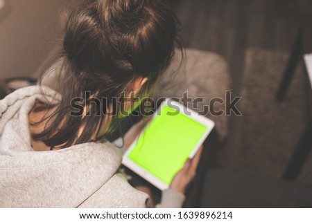 Young beautiful woman holding white tablet with copyspace - isolated on white background.
