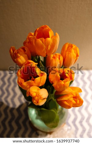 Bouquet of orange tulips on the table. Top view