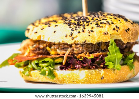 Sandwich hamburger with and mix of vegetables. Fast food. Delicious hamburger