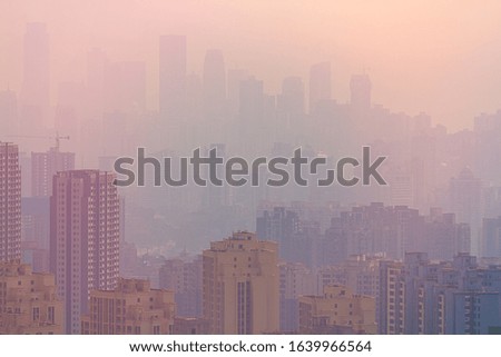 Blurred cityscape in sunrise haze. Chinese city of Chongqing. For a beautiful background, postcard, banner.