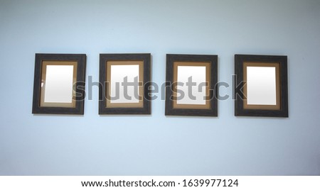 Four picture frames hung on the wall, isolated picture frame