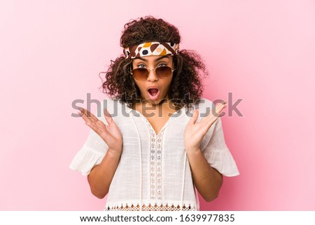 Young african american hipster woman isolated on pink background surprised and shocked.